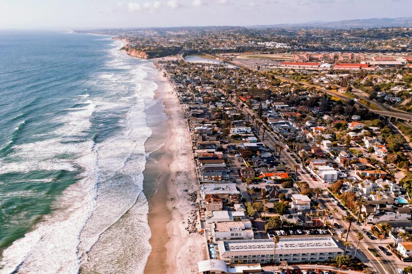 Aerial shot of the Del Mar coastline beach and houses.
