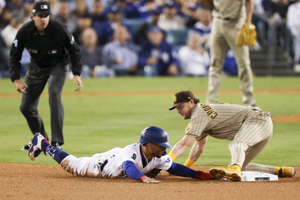 Dodgers baserunner Mookie Betts is tagged out by San Diego Padres second baseman Jake Cronenworth.