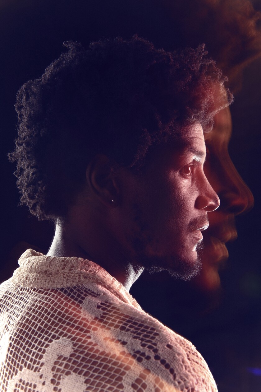 A dramatic multiple-exposure shot of composer Labrinth's profile against a black background.