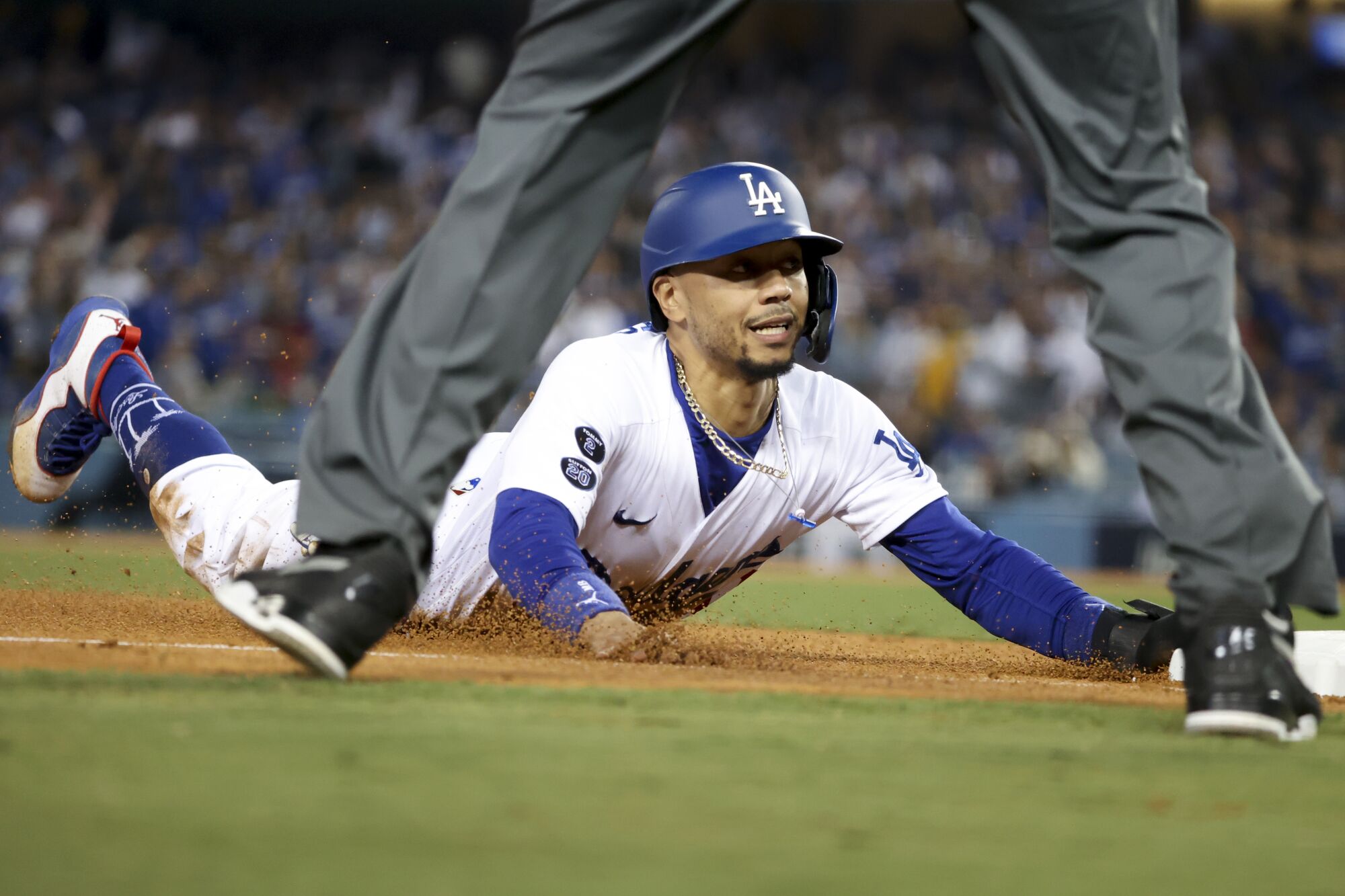 Dodgers' Mookie Betts slides into third in the eighth inning.