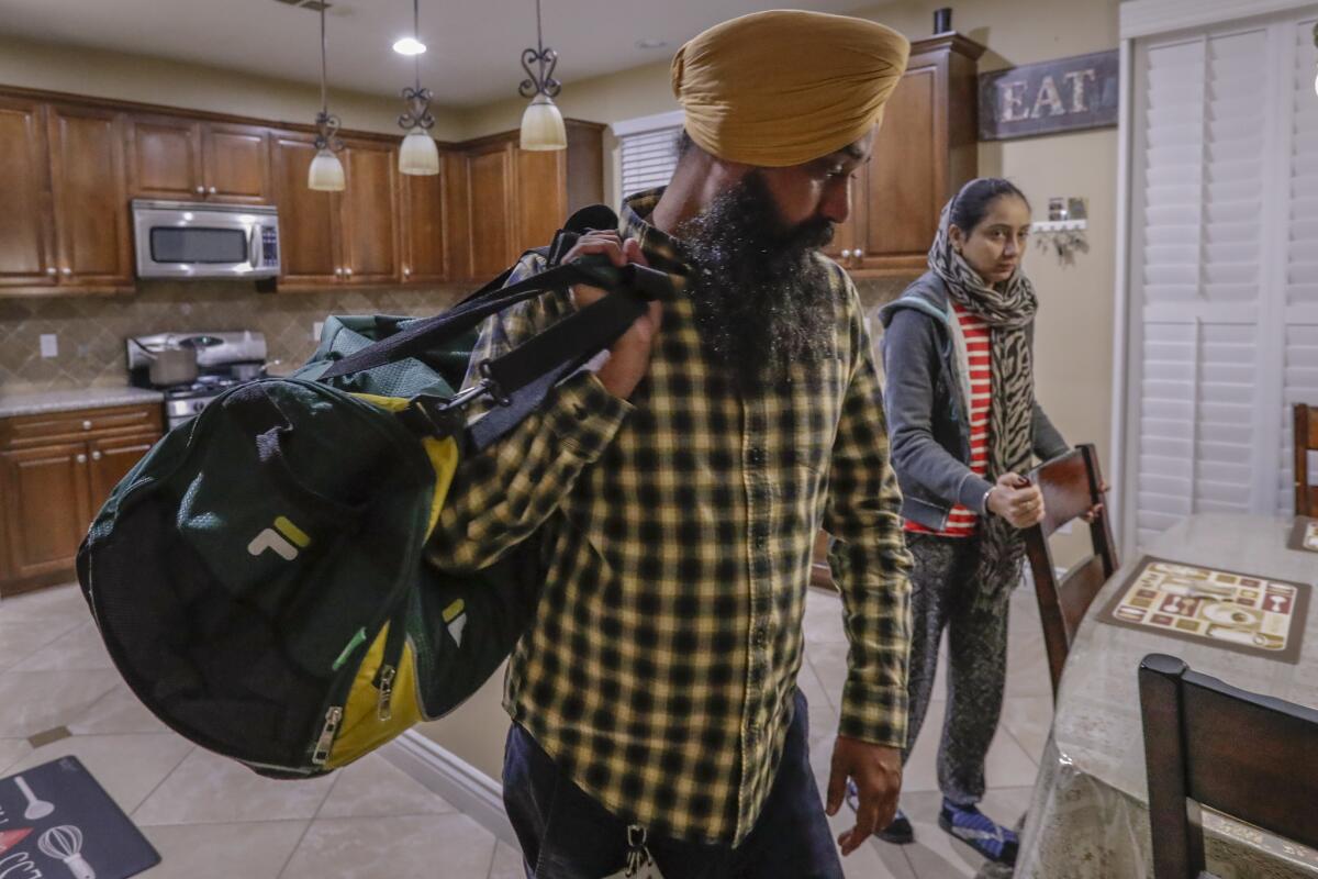 Singh says goodbye to his wife, Harjeet Kaur, as he leaves his Fontana home for Indiana. (Irfan Khan / Los Angeles Times)