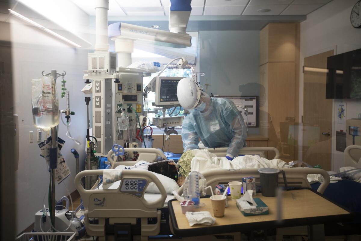 Nurse Ashley Cohagen works with an ICU patient last week at Providence Saint John's Health Center in Santa Monica.