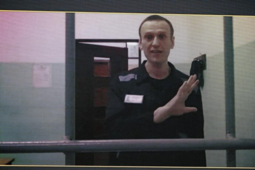 FILE - Russian opposition leader Alexei Navalny, is seen on a TV screen as he appears in a video link provided by the Russian Federal Penitentiary Service from the colony in Melekhovo, Vladimir region, during a hearing at the Russian Supreme Court in Moscow, Russia, on Wednesday, Aug. 23, 2023. A court in Russia has upheld a 19 year prison sentence against imprisoned Russian opposition leader Alexei Navalny. He was found guilty of charges of extremism at a hearing in August. (AP Photo/Alexander Zemlianichenko, File)