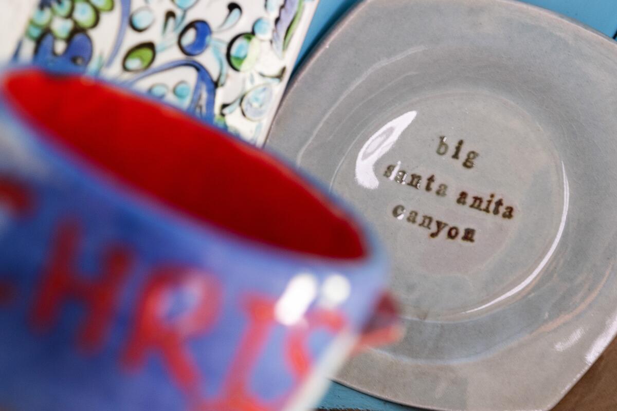 Ceramic plate reads "big santa anita canyon" in a hutch inside the Kastens' cabin.