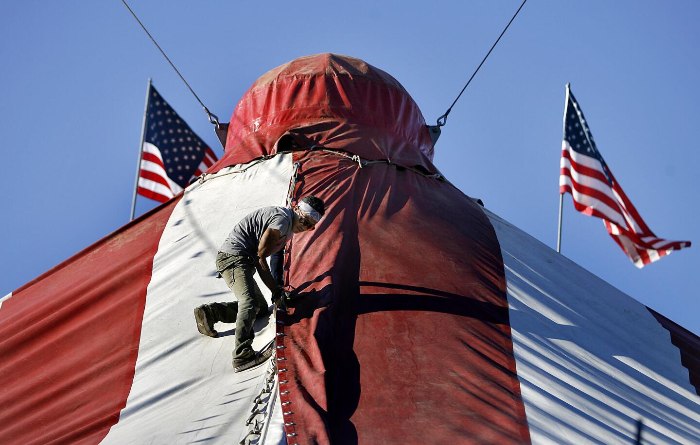 A circus performer ties together the top of the Ramos Circus tent on the Civic Center Auditorium's parking lot in Glendale on Tuesday, Nov. 20, 2012. The circus will be in town from Friday Nov. 23 tthrough Monday Dec. 3.