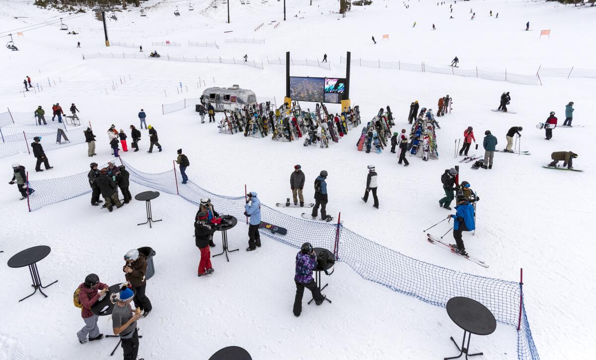 Small bar tables have been moved outside for skiers and snowboarders to eat and "social distance" at Mammoth Mountain.