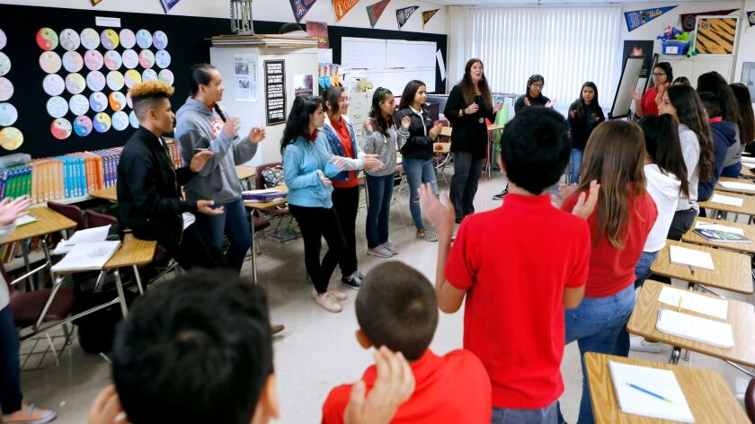 Roosevelt Middle School teacher Pam Zamaris uses restorative justice practices to communicate with students at the Glendale school. Above, students stand in a circle and discuss their emotions and problems.