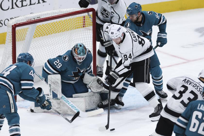 San Jose Sharks goalie Mackenzie Blackwood (29) defends against Los Angeles Kings defenseman.