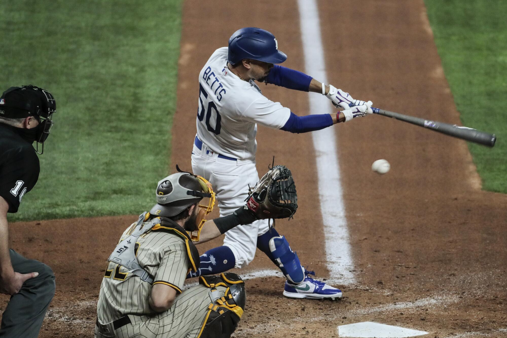 Dodgers right fielder Mookie Betts strikes out during the third inning Tuesday.