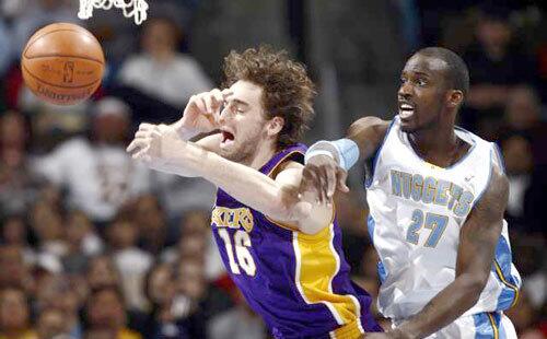 Nuggets center Johan Petro knocks a rebound from the hands of Lakers center Pau Gasol in the first quarter Friday night.