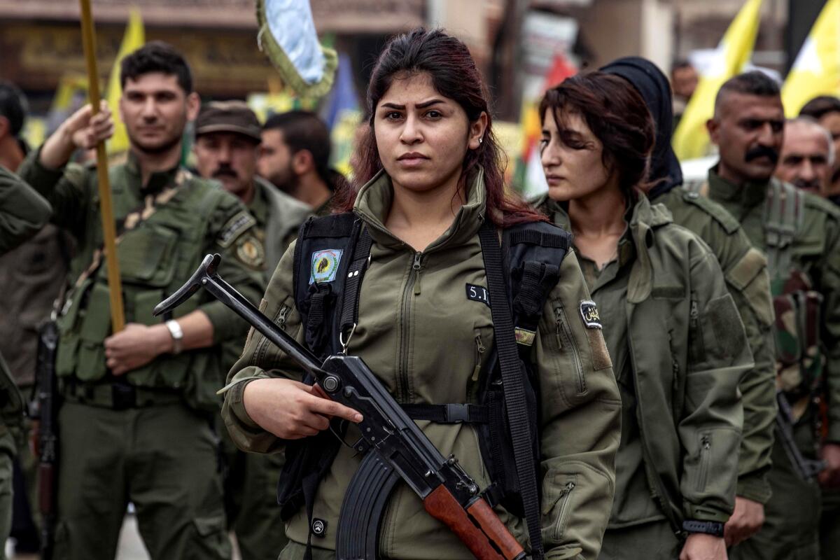 Members of a Kurdish police unit take part in a protest against Turkish threats in the northeastern Syrian city of Qamishli.