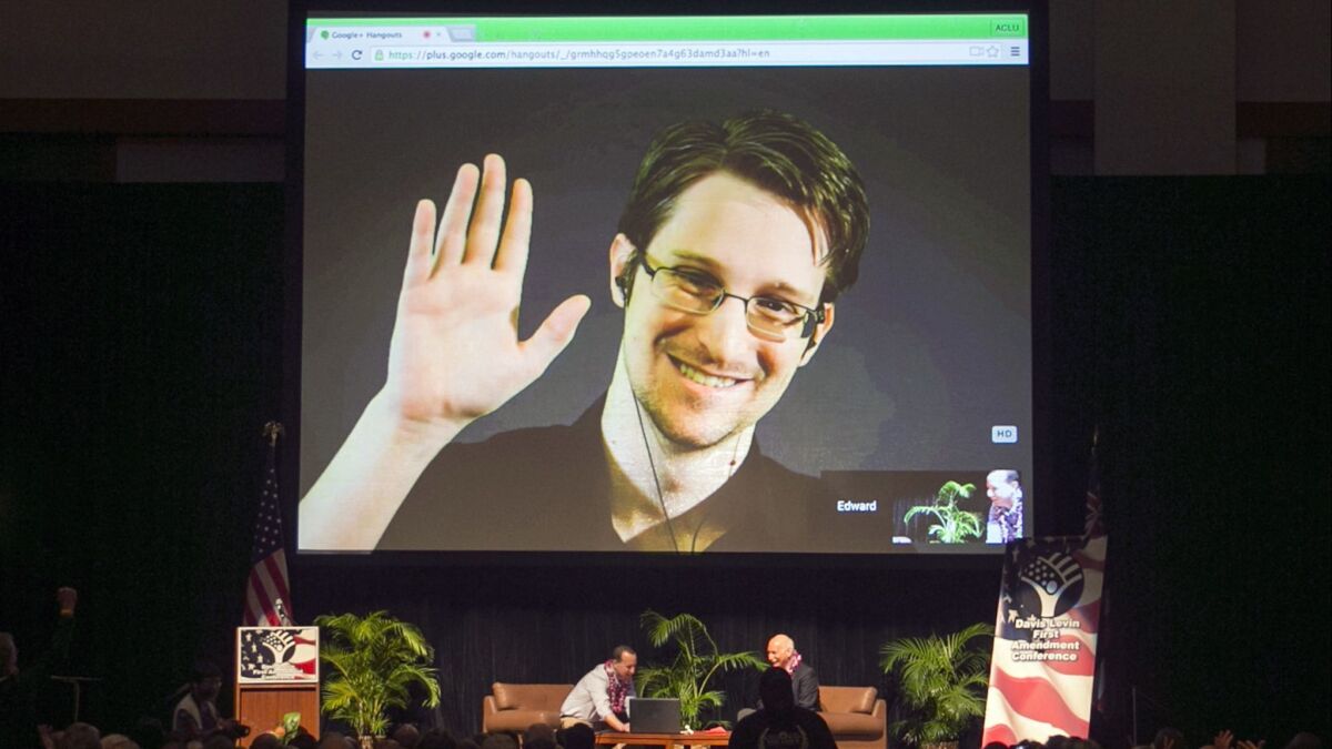 Whistleblower or traitor? Edward Snowden appears on a live video feed from Moscow in February 2015 at an event sponsored by ACLU Hawaii in Honolulu.