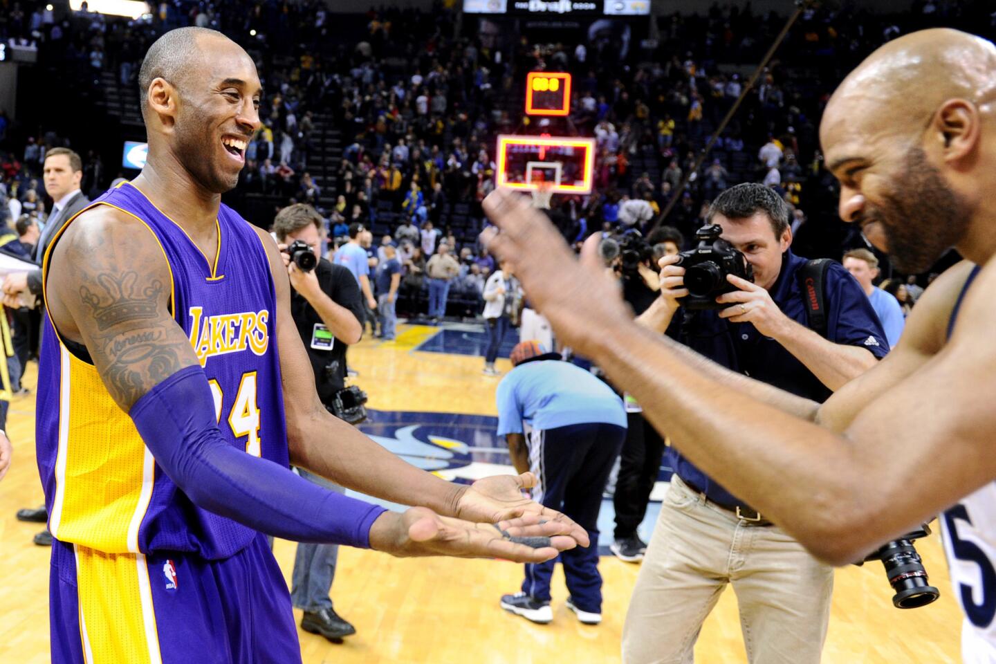 Lakers star Kobe Bryant and Grizzlies forward Vince Carter greet each other after a game in Memphis, Tenn., on Feb. 24, 2016.