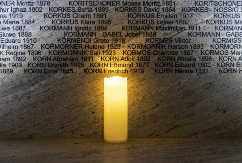 FILE -A light illuminates names at the Shoah Wall of Names Memorial during the inauguration ceremony, in Vienna, Austria, Nov. 9, 2021. Vienna born Holocaust survivor Gertrude Pressburger, who became famous during the 2016 presidential campaign in Austria with a video message in which as "Mrs. Gertrude" she warned of hatred and exclusion triggered by the far right, has died at age 94. (AP Photo/Lisa Leutner, File)