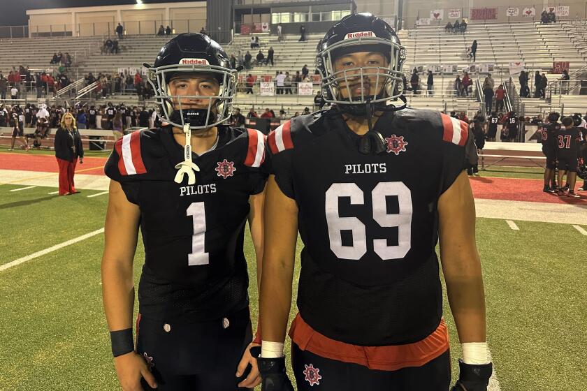 Steven Perez, left, and Salvador Zamora pose for a photo after Banning's defeat of Dorsey on Friday night.