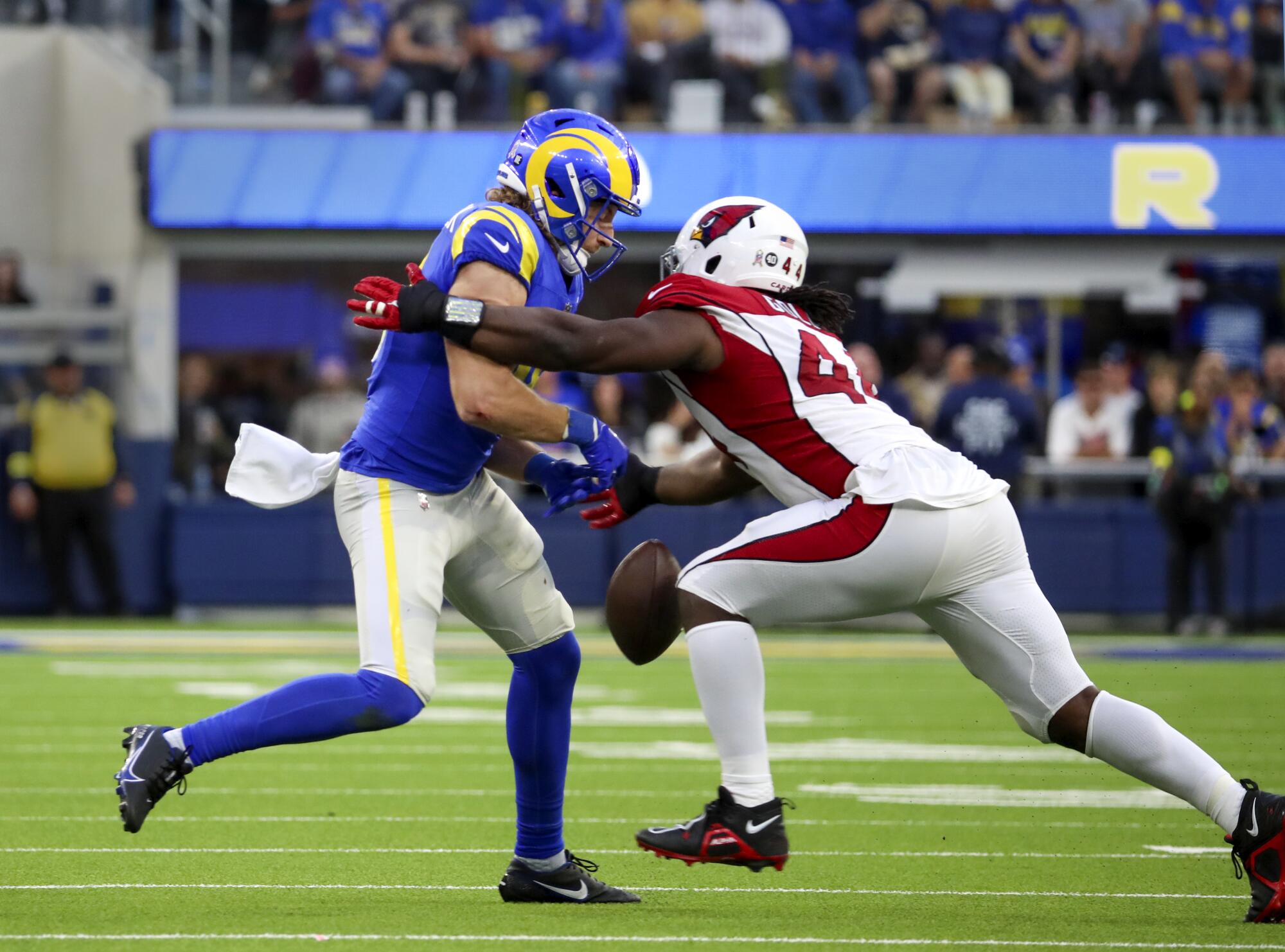 Cardinals linebacker Markus Golden, right, breaks up a pass intended for Rams wide receiver Ben Skowronek.