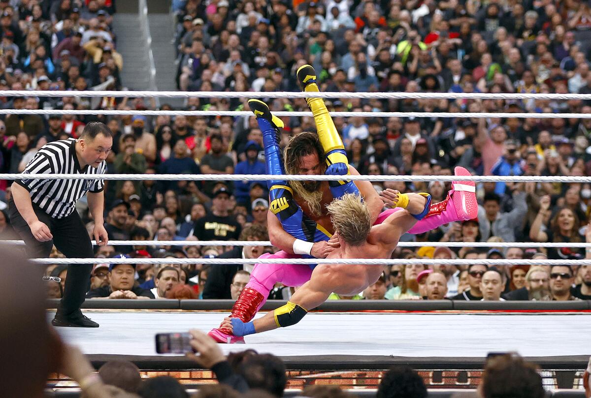 Seth Rollins, top, wrestles Logan Paul at WrestleMania 39.