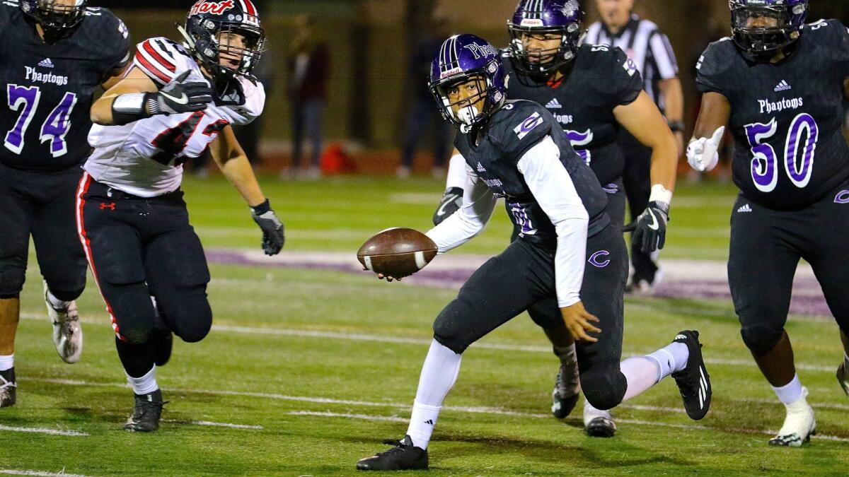Freshman quarterback Bryce Young of Cathedral scrambles for a first down in the second quarter of Friday night's 34-17 victory over Hart in the first round of the Southern Section Division 3 playoffs in Los Angeles.
