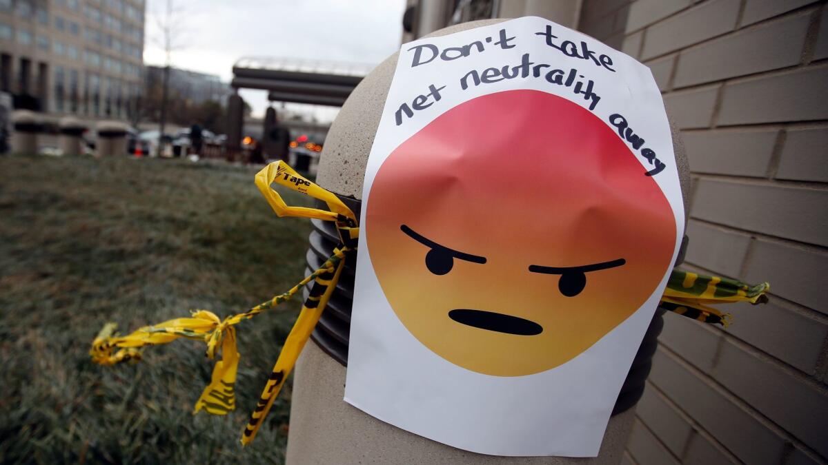 A sign with an emoji reads "Don't take net neutrality away" is posted outside the Federal Communications Commission (FCC), in Washington on Dec. 14.