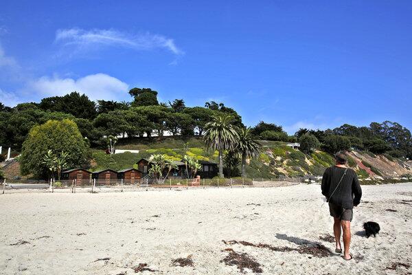 Geoff Pryce of Santa Barbara walks past the massive beachfront estate owned by reclusive heir Huguette Clark.