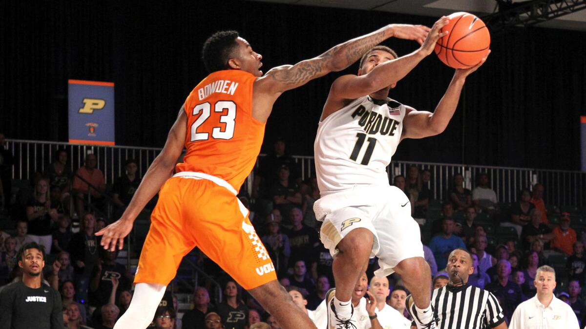 Purdue guard P.J. Thompson has his layup challenged by Tennessee guard Jordan Bowden during their opening game in the Battle 4 Atlantis tournament.