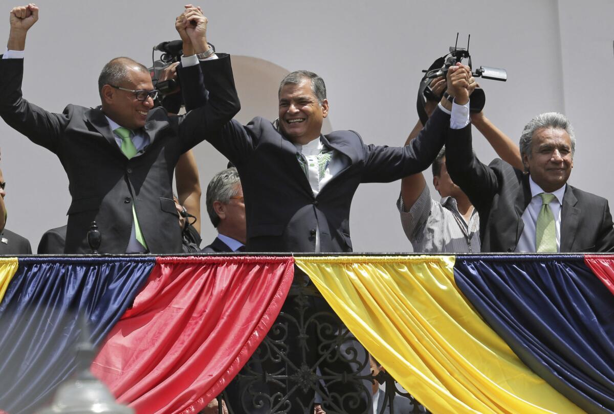 Presidential candidate Lenin Moreno, right, with Ecuadorean President Rafael Correa, center, and Vice President Jorge Glas wave to supporters from the government palace balcony in Quito on Monday.