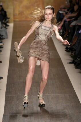 A model falls as she walks the runway at the Herve Leger fall 2009 fashion show.