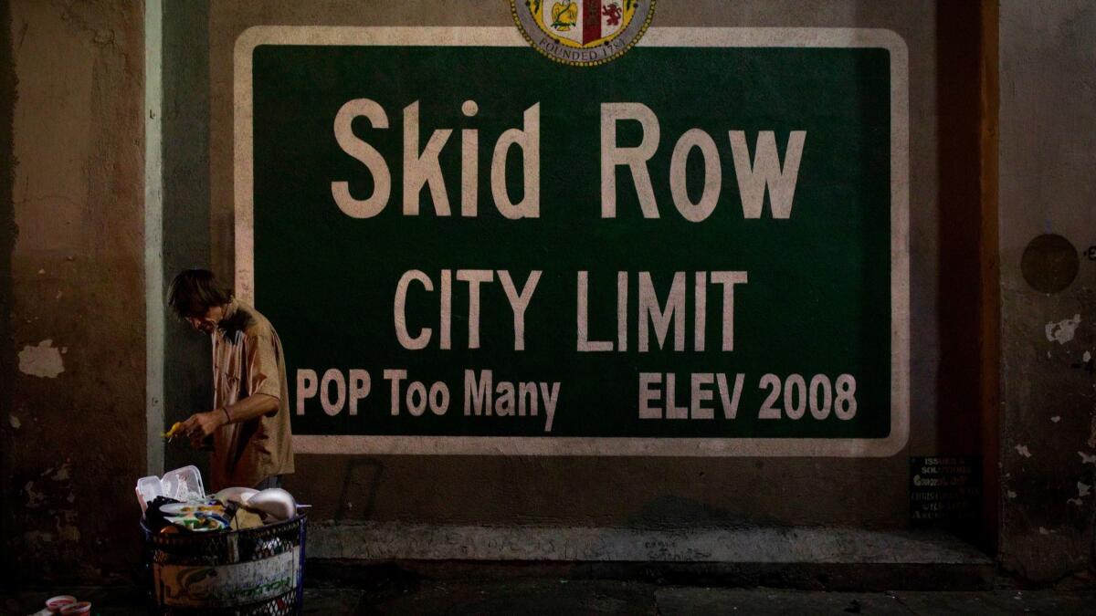 A homeless man takes food from a trash can in Los Angeles' skid row area in 2017.