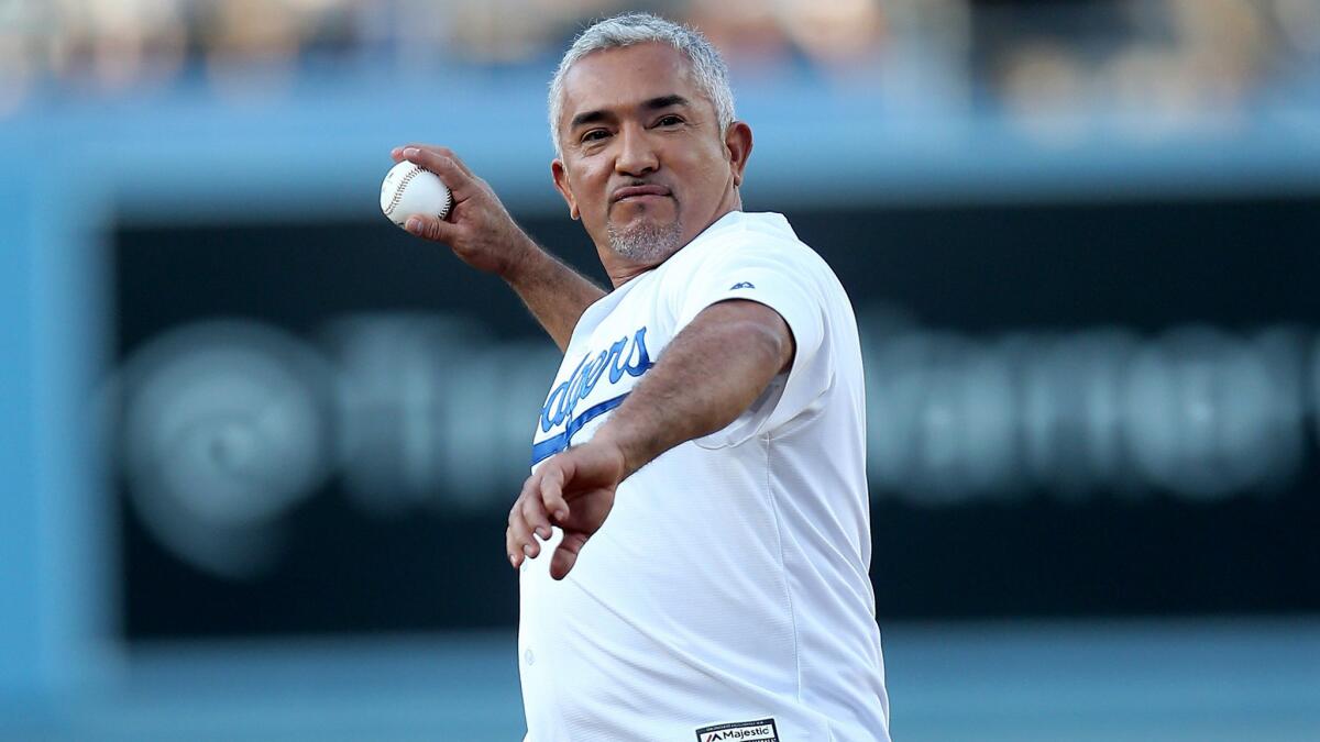 Cesar Millan throws out the frrst pitch before a game between the Philadelphia Phillies and the Los Angeles Dodgers on Tuesday night at Dodger Stadium.