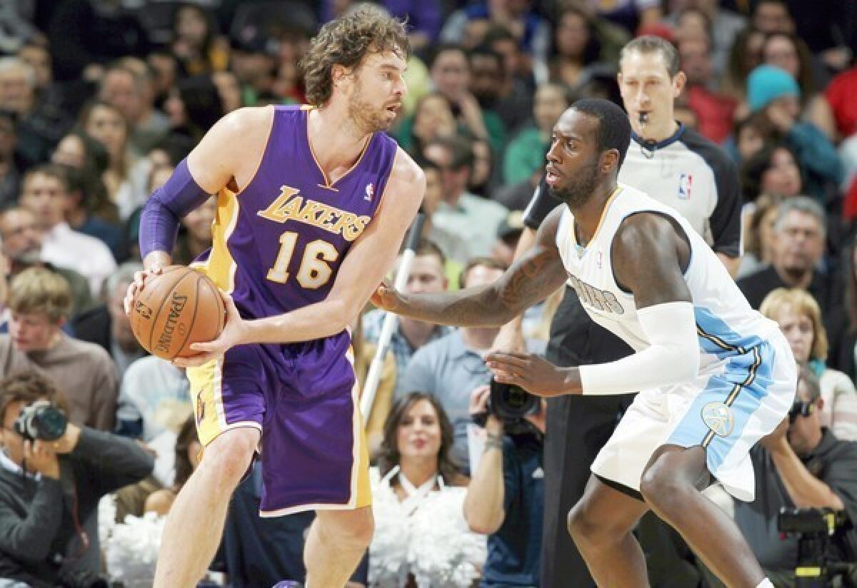 Lakers power forward Pau Gasol works in the post against Nuggets power forward J.J. Hickson in the second half of a game earlier this season.