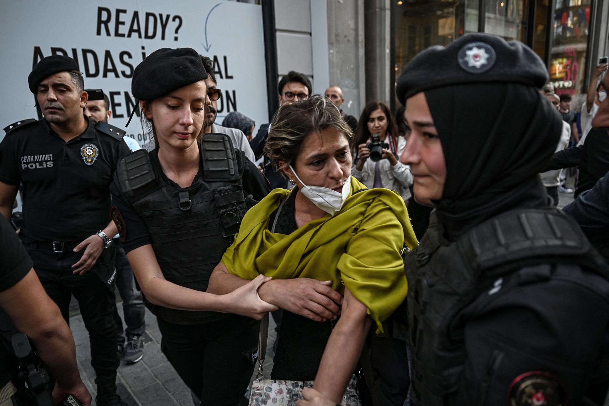 Turkish riot police detain a protester during demonstration in support of Mahsa Amini