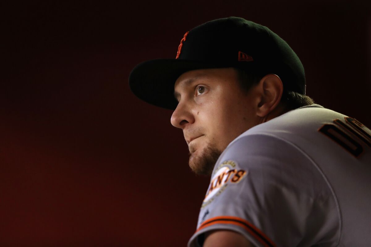 The Giants' Alex Dickerson sits in the dugout before the MLB game against the Arizona Diamondbacks at Chase Field on June 23, 2019 in Phoenix.