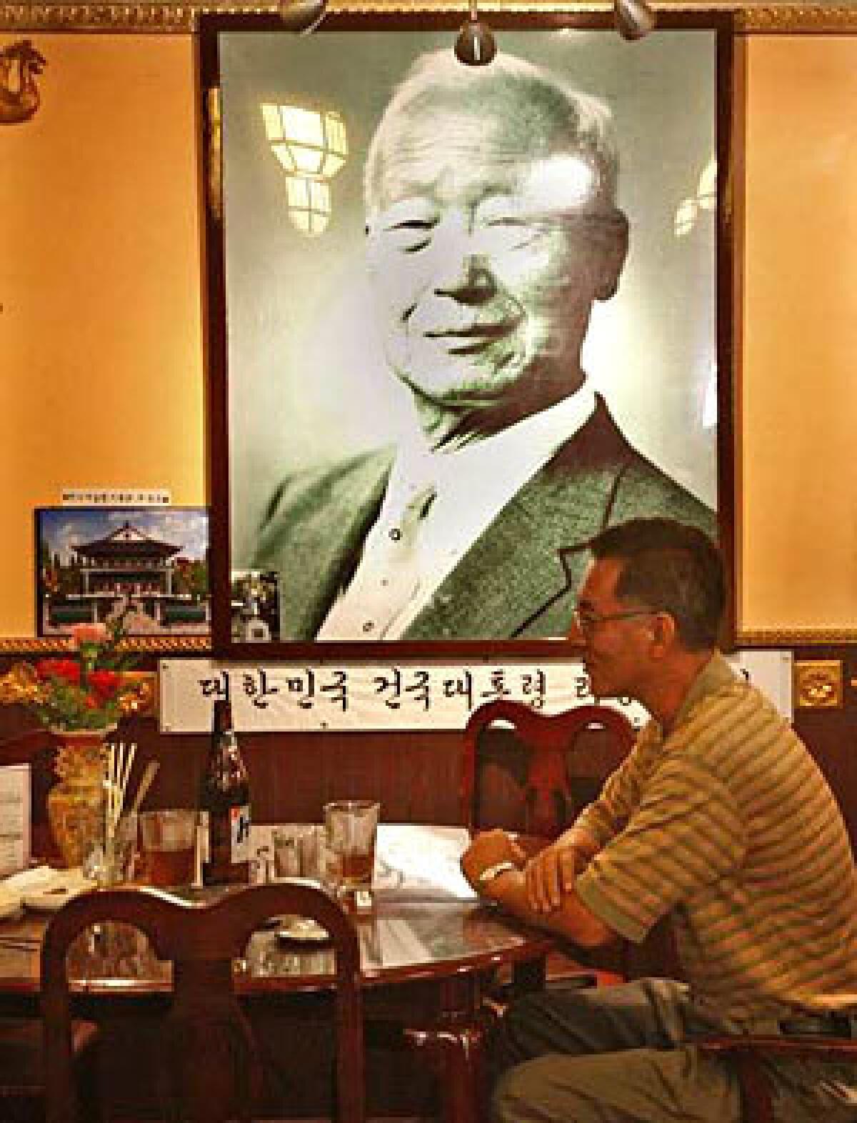TRIBUTE: E-Hwa Jang displays a portrait of South Korean leader Syngman Rhee.