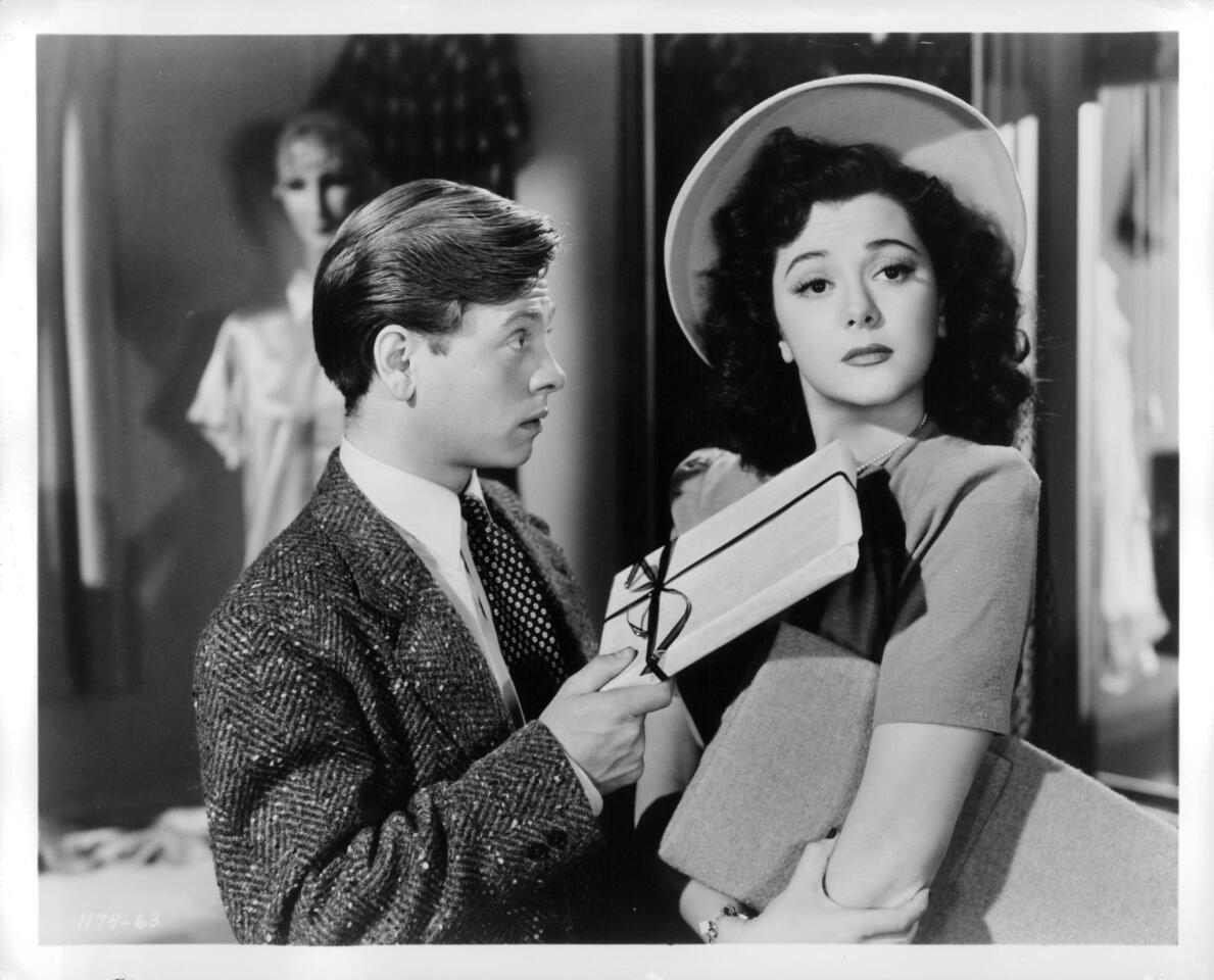 MGM's popular franchise of "Andy Hardy" family comedies, which began with 1937's "A Family Affair," proved a perfect match for the tireless Rooney. Pictured: Rooney hands a gift to Ann Rutherford in "Andy Hardy's Private Secretary" (1941).