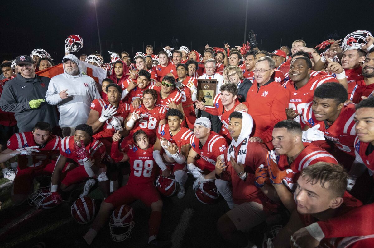 Mater Dei players pose for photos after defeating Servite.