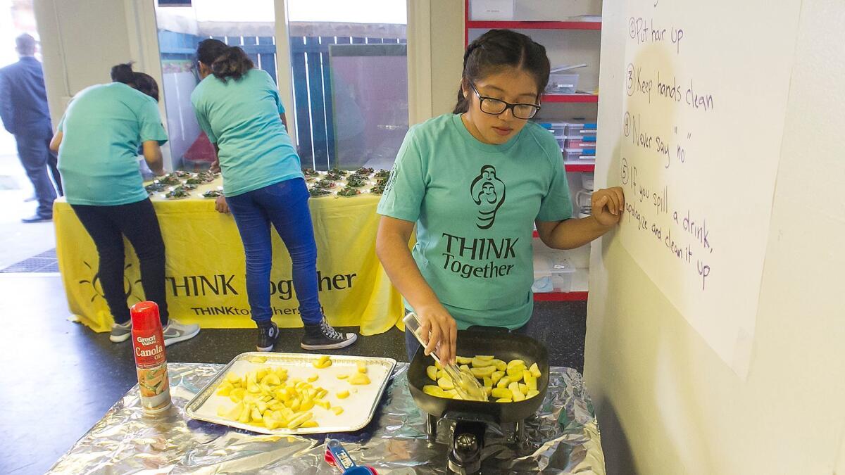 Shalimar Learning Center culinary team member Maria Arellano cooks for the 20th anniversary celebration.