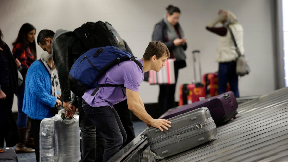 A traveler gathers his luggage at San Francisco International Airport.