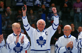 TORONTO, ON - FEBRUARY 8: Former Leafs Captain George Armstrong waves to the crowd beside.