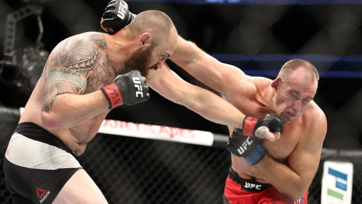 Travis Browne and Oleksiy Oliynyk trade blows during their heavyweight bout Saturday. To see more images from UFC 213, click on the photo above.