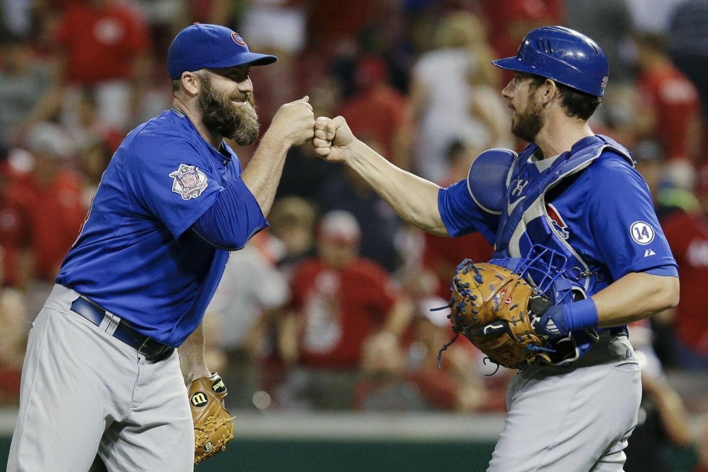 Jason Motte celebrates with catcher Taylor Teagarden after the Cubs' 6-5 win.