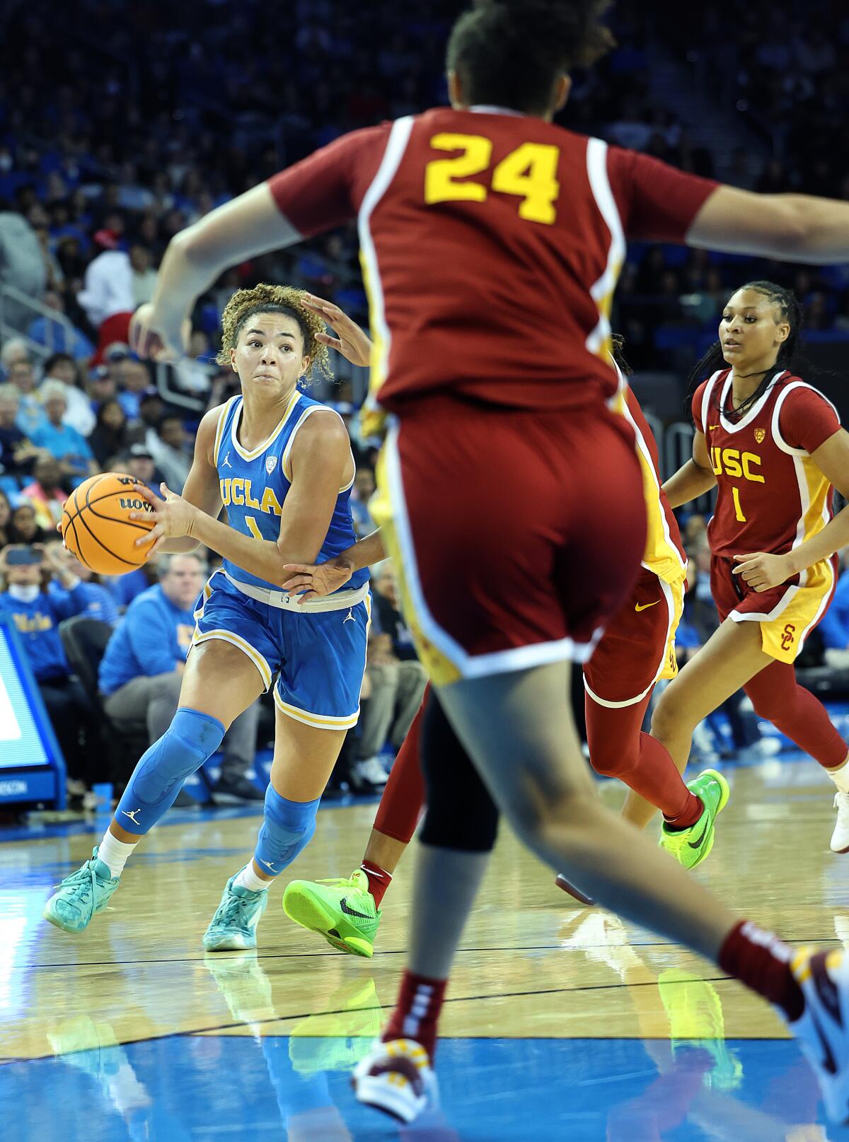 UCLA's Kiki Rice, left, drives to the basket against USC on Saturday.