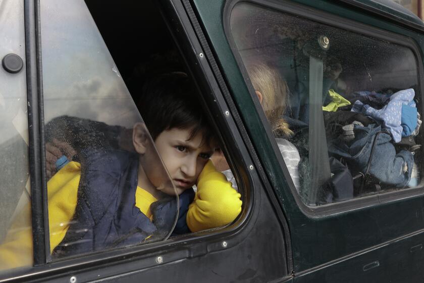 An ethnic Armenian boy from Nagorno-Karabakh, looks out from a car window upon his arrival in Goris, Armenia's Syunik region, Monday, Sept. 25, 2023. (AP Photo/Vasily Krestyaninov)