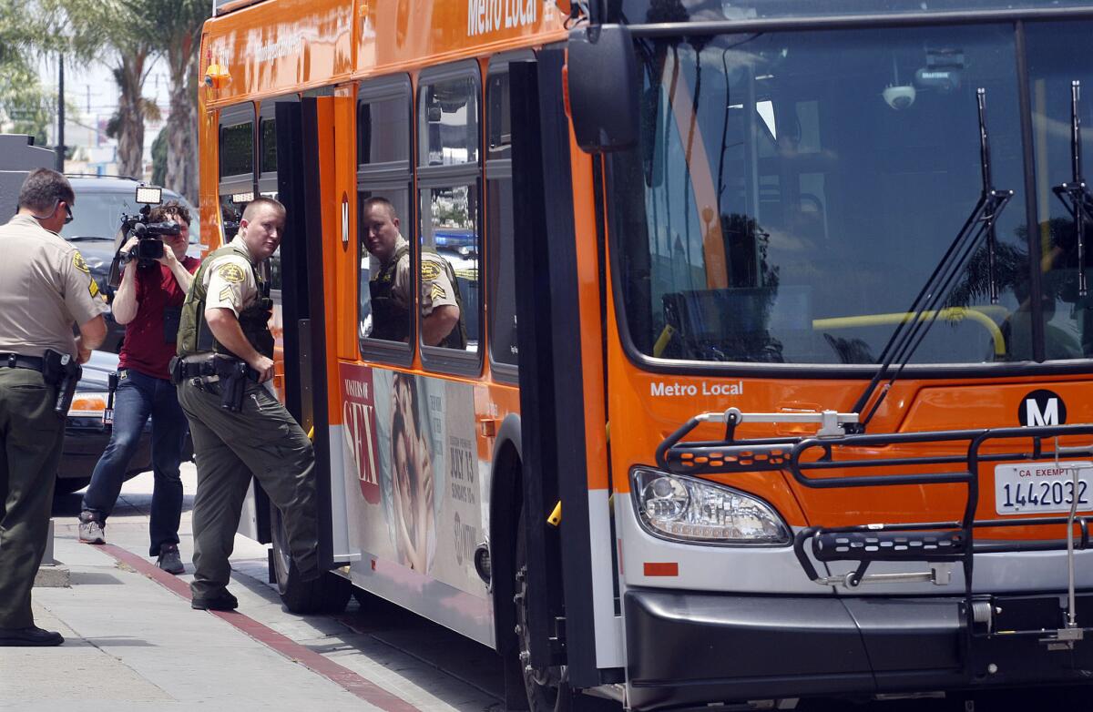 Los Angeles County sheriff's officials investigate a stabbing aboard a Metro bus Friday morning at Slauson Avenue and Atlantic Boulevard in Maywood.
