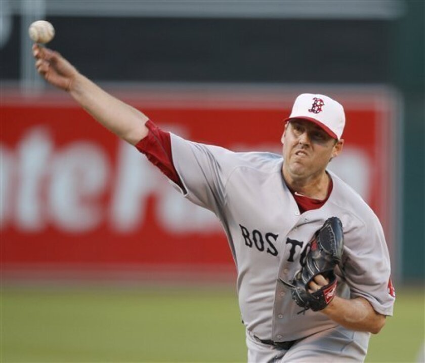 Boston Red Sox starting pitcher John Lackey works against the Oakland Athletics during the first inning of their baseball game in Oakland, Calif., Saturday, Sept. 11, 2010. (AP Photo/Eric Risberg)