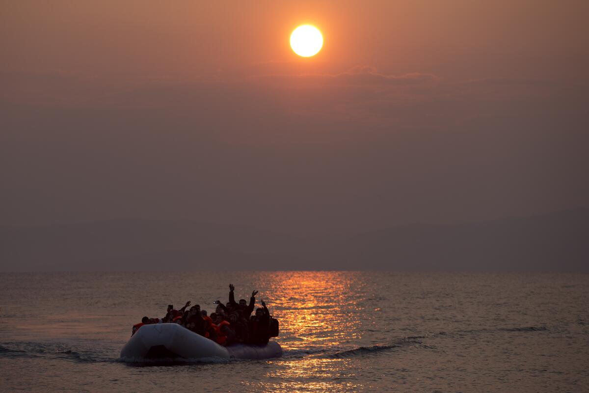 File - In this Sunday, March 20, 2016, file photo, the sun rises as migrants and refugees on a dingy arrive at the shore of the northeastern Greek island of Lesbos, after crossing the Aegean sea from Turkey. The European Union's border and coast guard is under pressure following a series of allegations that it was involved in illegal pushbacks of migrants. Frontex is an increasingly powerful agency that monitors the 27-nation bloc's external borders. (AP Photo/Petros Giannakouris, File)
