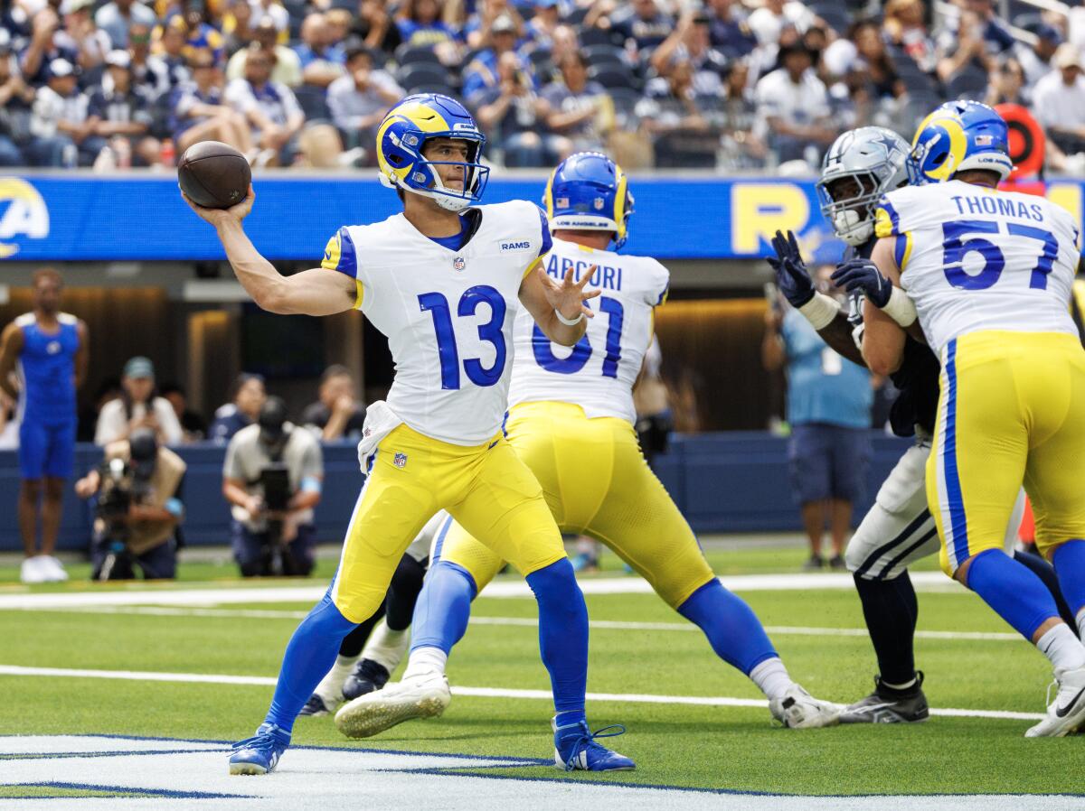 Rams quarterback Stetson Bennett (13) throws a pass against the Dallas Cowboys in their preseason game.