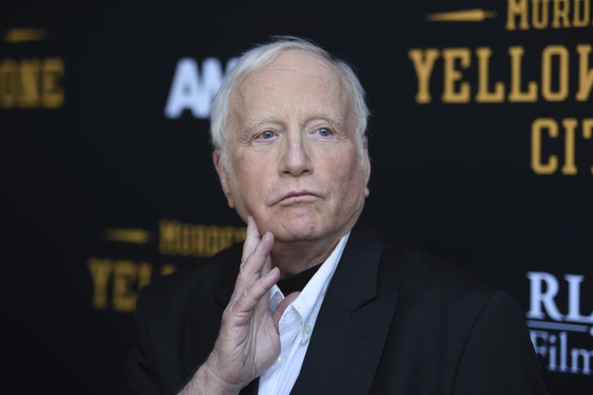 Richard Dreyfuss looks up with a hand on his chin