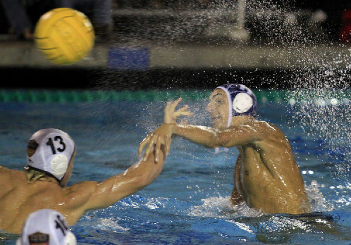 Newport Harbor High's Mitchell Mendoza, right, scores on Huntington Beach's Gavin Wuerfel (13) during the first half in a Sunset League match on Wednesday in Newport Beach.