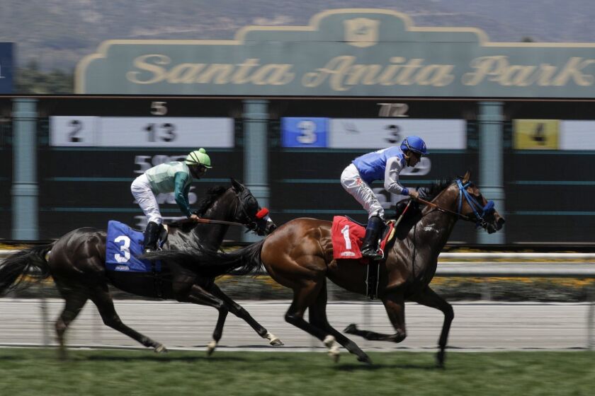FILE - In this June 23, 2019 file photo Eddie Haskell, right, with jockey Kent Desormeaux aboard, win the third race during the last day of the winter/spring meet at the Santa Anita Park race track in Arcadia, Calif. Governor Gavin Newsom signed a law, Wednesday June 26,2019 that would give the California Horsing Racing Board the authority to immediately suspend the license of Santa Anita. Thirty horses have died at the track in recent months. (AP Photo/Chris Carlson, File)