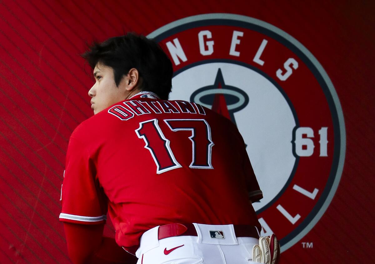 Shohei Ohtani has his back turned inside the Angels dugout.